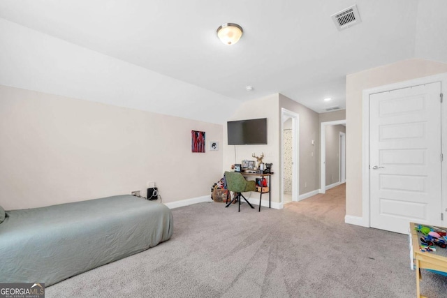 bedroom featuring light carpet and vaulted ceiling