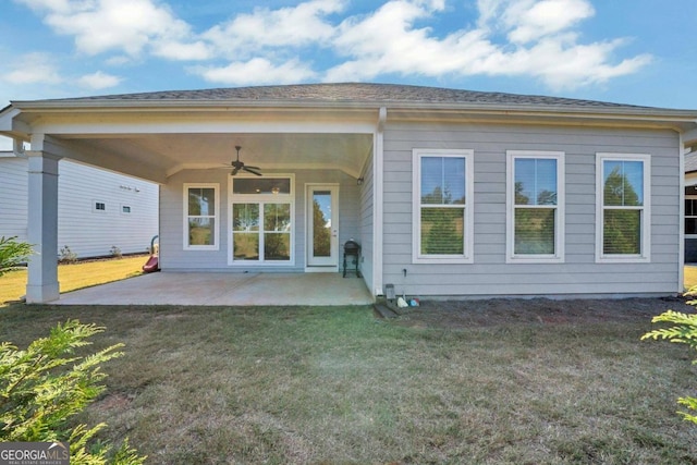 back of property with a yard, a patio area, and ceiling fan