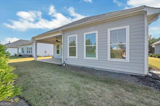 back of property featuring a yard, a patio area, and ceiling fan