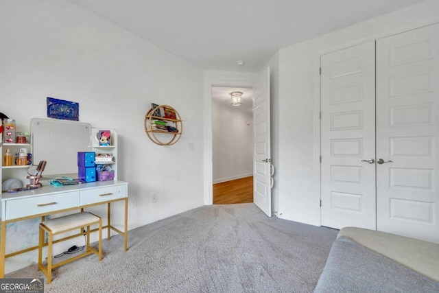 bedroom featuring light carpet and a closet