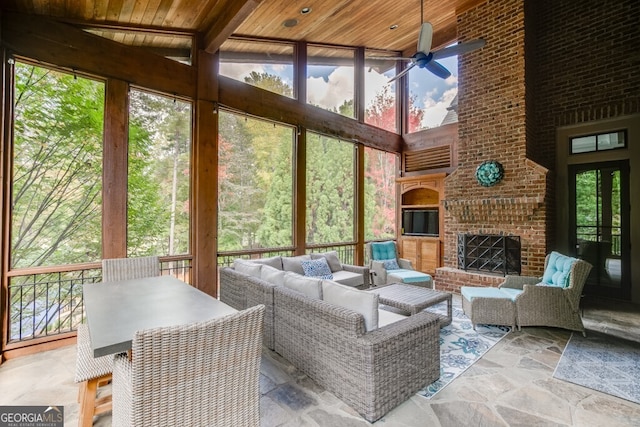 sunroom / solarium with an outdoor brick fireplace, a wealth of natural light, wooden ceiling, and lofted ceiling with beams