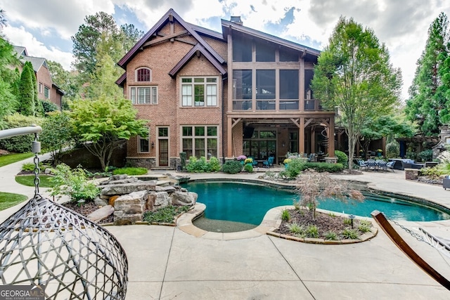 view of pool featuring a sunroom and a patio