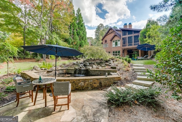 view of patio featuring a sunroom