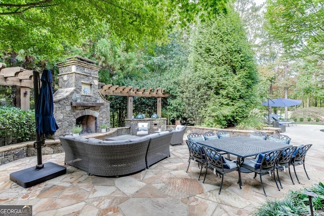 view of patio featuring an outdoor living space with a fireplace