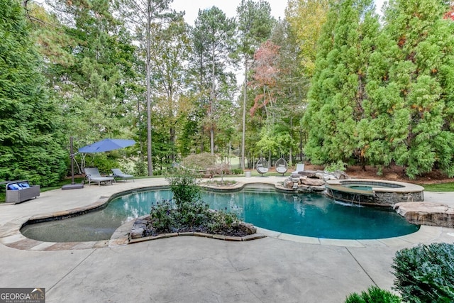 view of pool featuring an in ground hot tub and a patio area