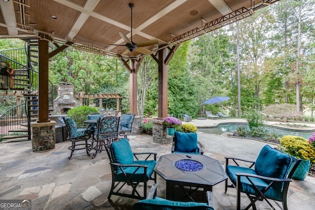 view of patio / terrace featuring an outdoor stone fireplace