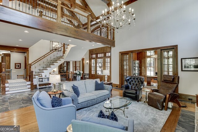 living room featuring an inviting chandelier and a high ceiling