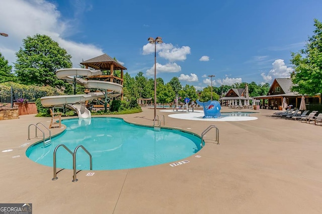 view of pool with a gazebo, a water slide, and a patio area