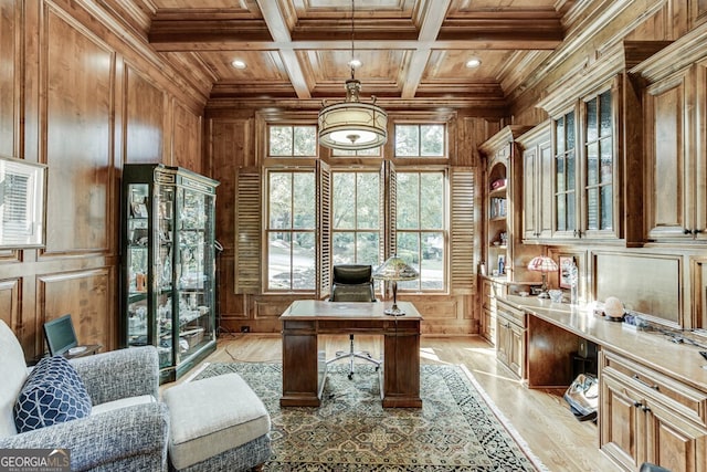 office space with coffered ceiling, crown molding, wooden ceiling, beamed ceiling, and light hardwood / wood-style floors