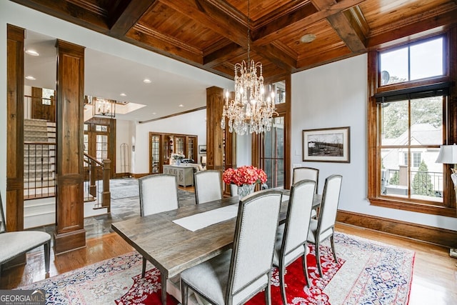 dining area with beam ceiling, crown molding, light hardwood / wood-style flooring, and wooden ceiling