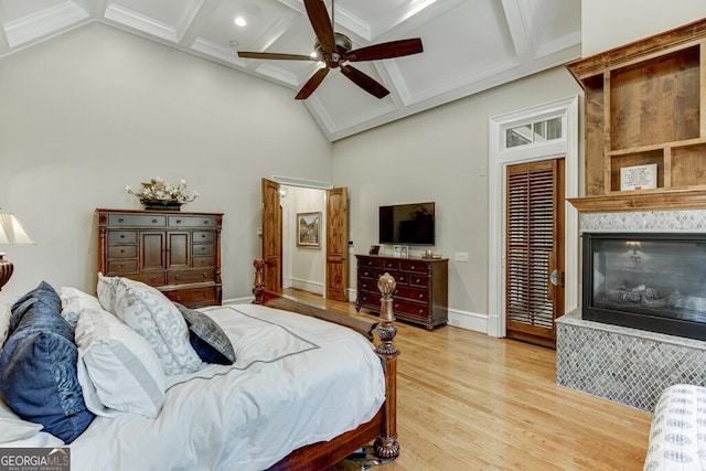 bedroom featuring crown molding, ceiling fan, coffered ceiling, light hardwood / wood-style floors, and beamed ceiling