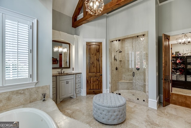 bathroom featuring a towering ceiling, vanity, a chandelier, and independent shower and bath