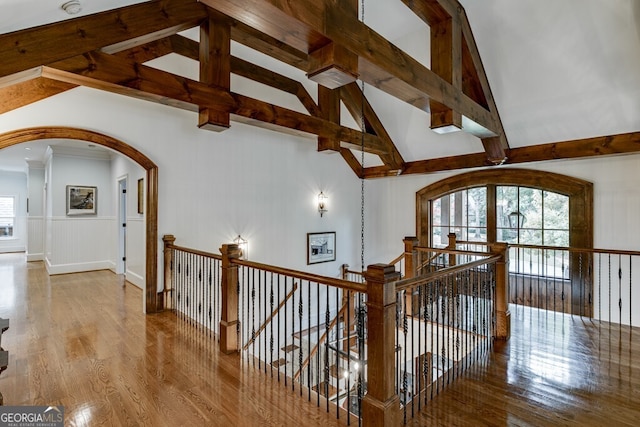 hall with vaulted ceiling with beams and hardwood / wood-style floors