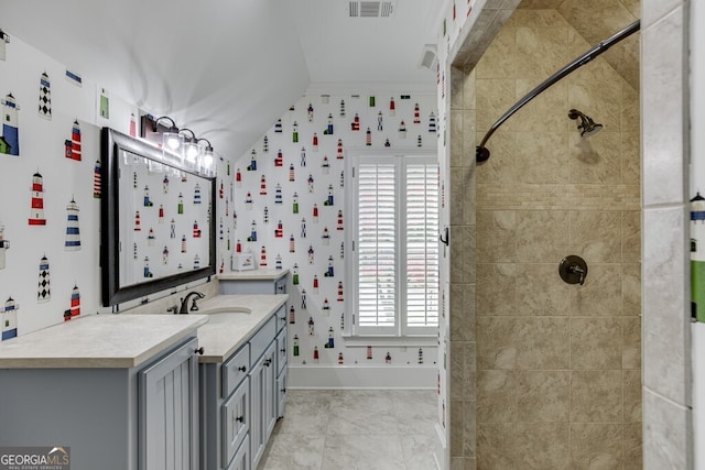 bathroom with vanity, crown molding, and a shower