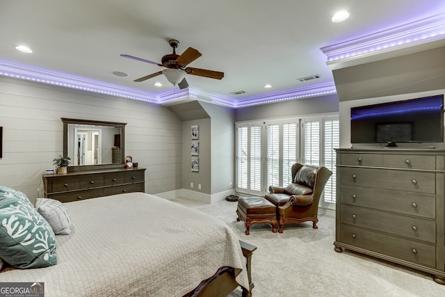 carpeted bedroom featuring wooden walls, ornamental molding, and ceiling fan