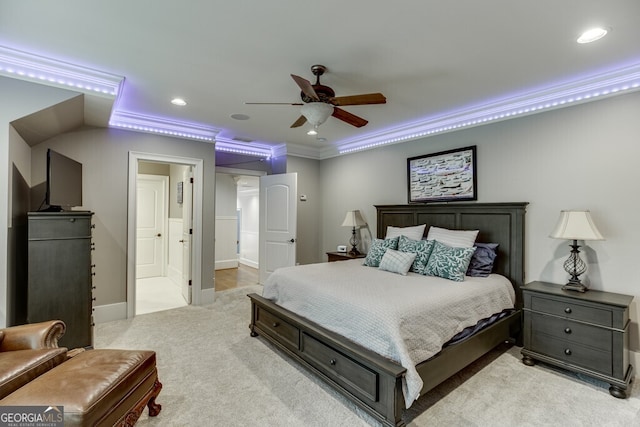 carpeted bedroom with crown molding, ceiling fan, and ensuite bathroom