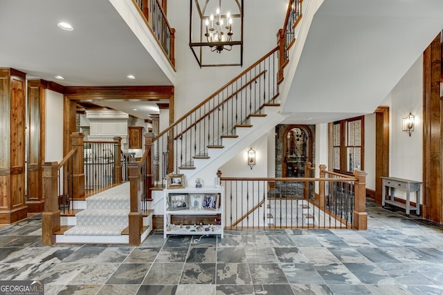 staircase with an inviting chandelier