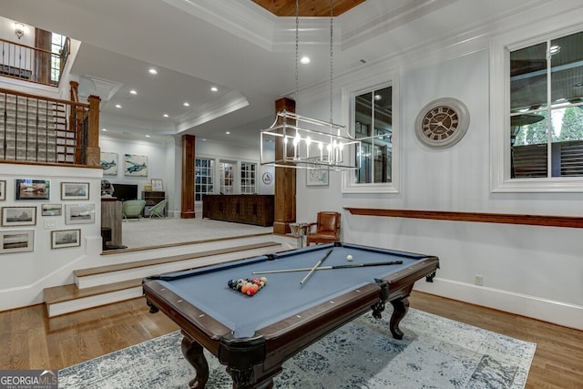 recreation room featuring crown molding, billiards, a tray ceiling, and hardwood / wood-style floors