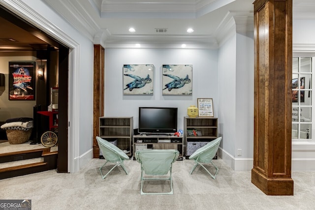 living area with ornate columns, crown molding, carpet flooring, and a tray ceiling