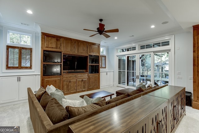 living room featuring ornamental molding, light colored carpet, and a healthy amount of sunlight