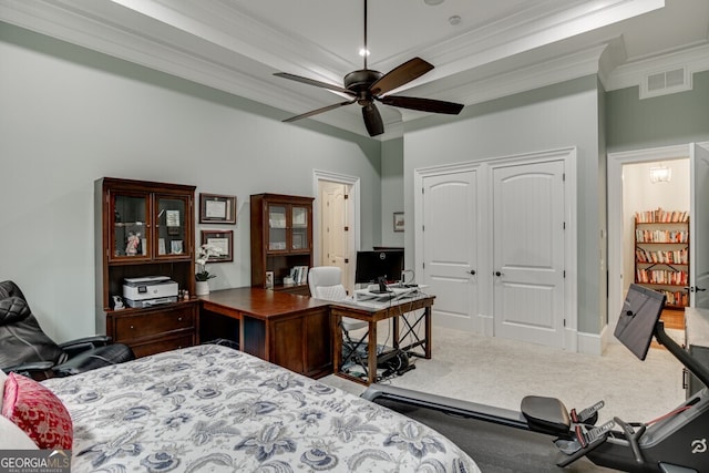 bedroom featuring ceiling fan, ornamental molding, a closet, and carpet