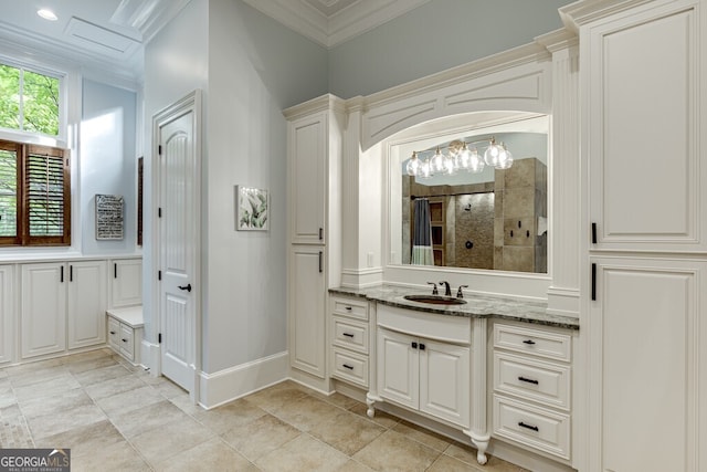 bathroom featuring crown molding, tiled shower, and vanity