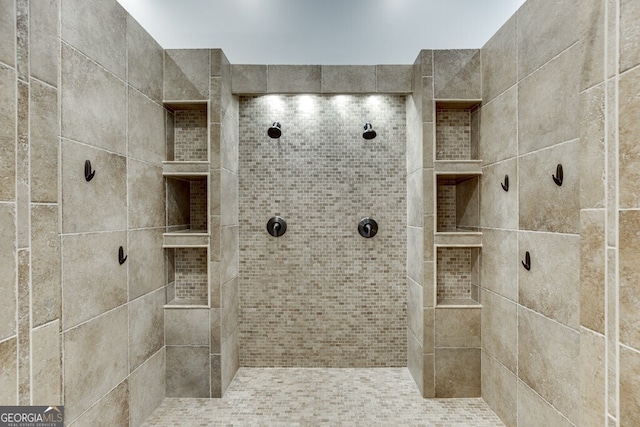 bathroom with tiled shower