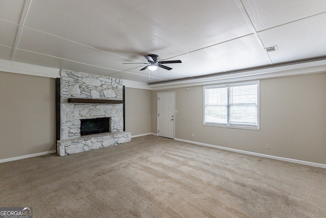 unfurnished living room with light colored carpet, a fireplace, and ceiling fan