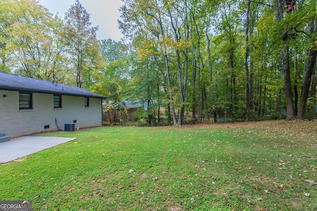 view of yard featuring a patio area and central AC unit