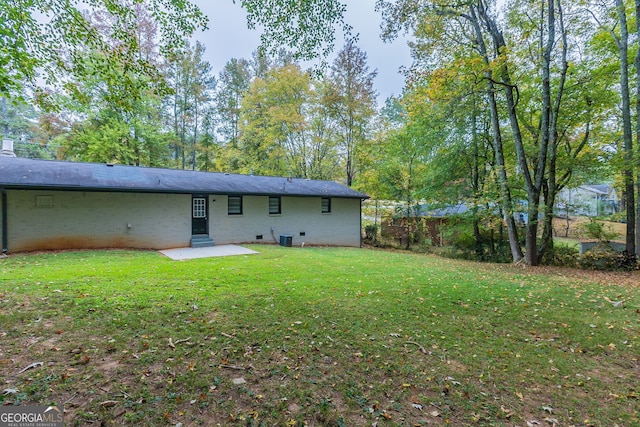 rear view of property with a patio and a lawn