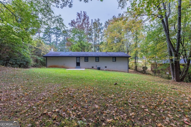 rear view of property with a yard and a patio area