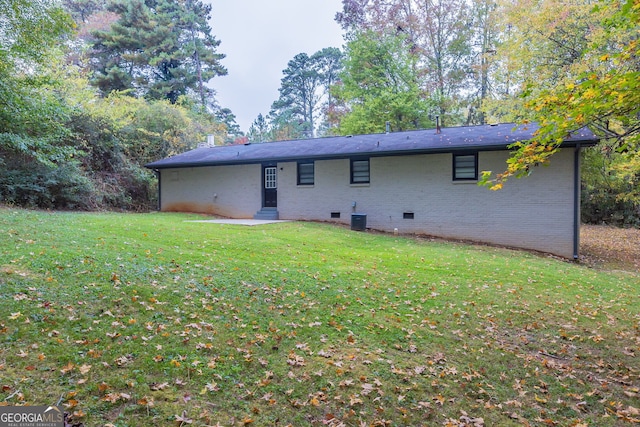 back of property with a lawn and cooling unit