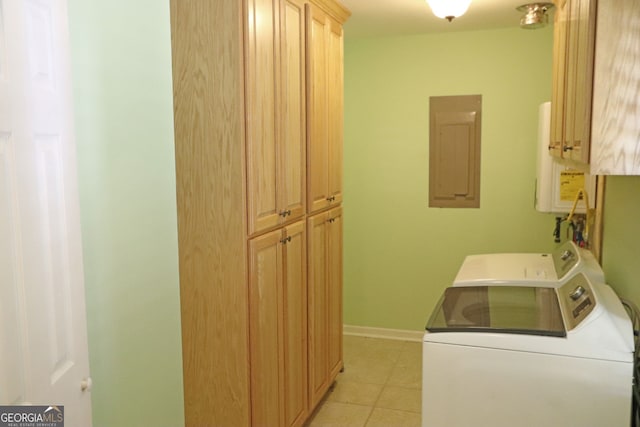 laundry room featuring cabinets, electric panel, light tile patterned floors, washing machine and clothes dryer, and water heater