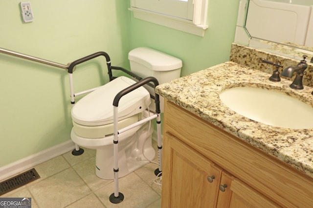 bathroom featuring toilet, vanity, and tile patterned floors