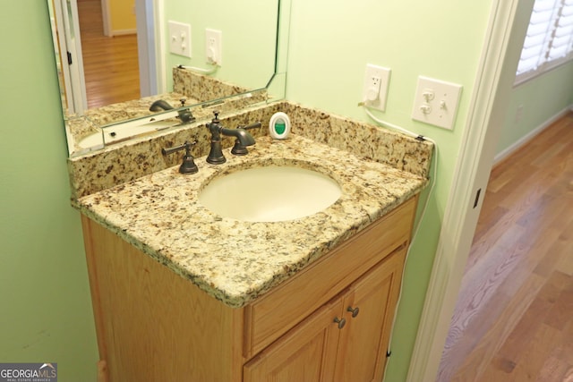 bathroom with vanity and hardwood / wood-style floors