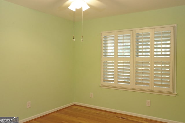 spare room featuring ceiling fan and light hardwood / wood-style flooring