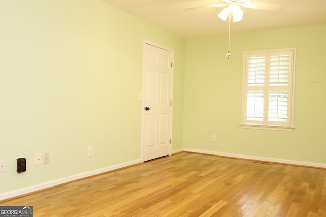 unfurnished room with ceiling fan and light wood-type flooring