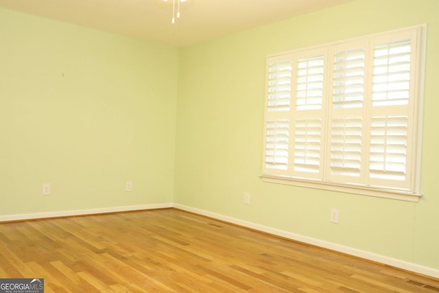 spare room with light hardwood / wood-style flooring and ceiling fan