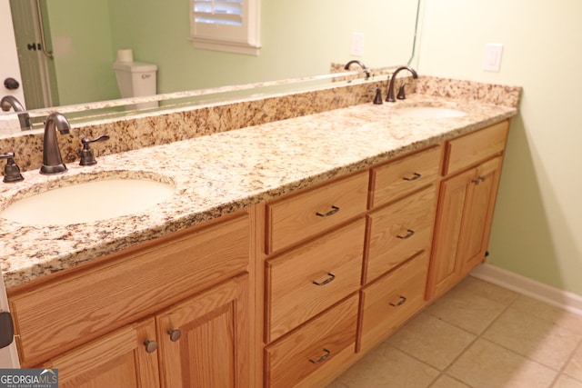 bathroom featuring vanity, toilet, and tile patterned floors