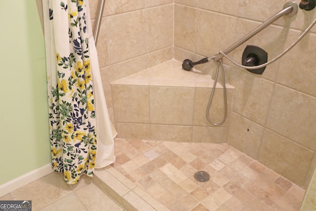 bathroom with tile patterned floors and a shower with shower curtain