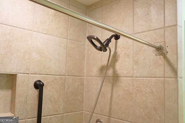 interior details featuring a tile shower