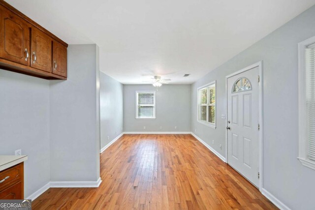 interior space with ceiling fan and light hardwood / wood-style flooring