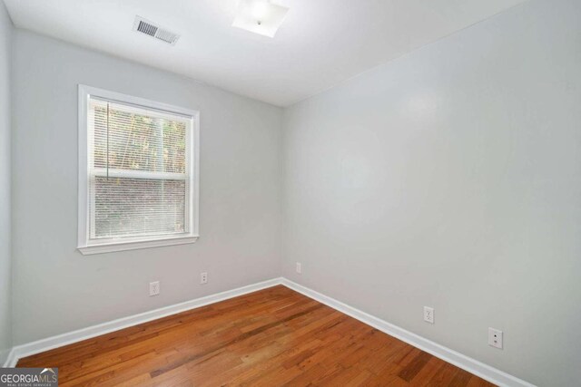 empty room with hardwood / wood-style floors