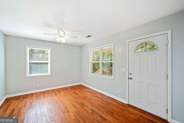 foyer with hardwood / wood-style floors, ceiling fan, and plenty of natural light