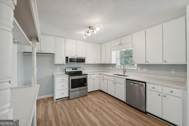 kitchen featuring sink, white cabinets, and appliances with stainless steel finishes