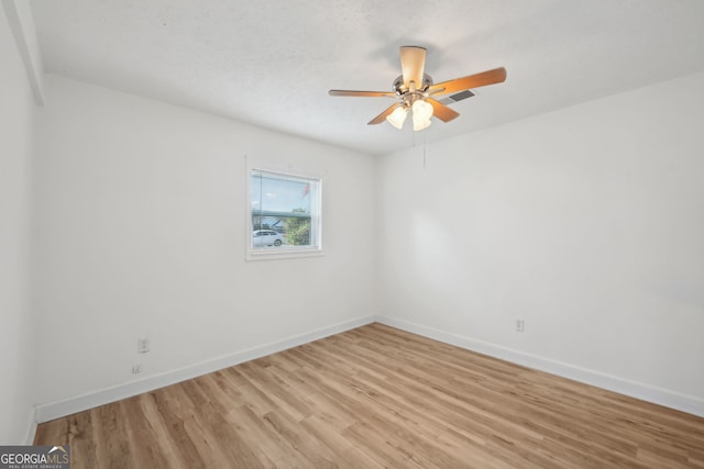 unfurnished room featuring ceiling fan and light wood-type flooring