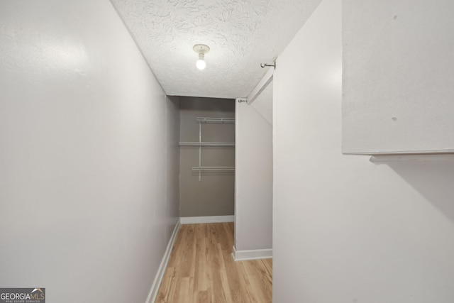 spacious closet with light hardwood / wood-style flooring