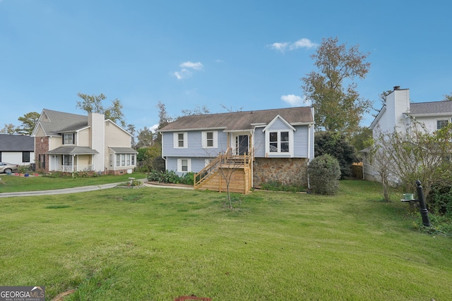 bi-level home with a front lawn