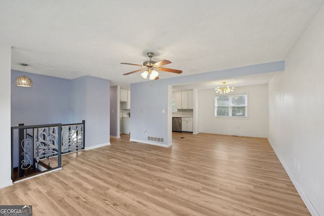 unfurnished living room featuring light hardwood / wood-style flooring and ceiling fan with notable chandelier