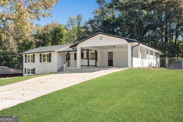 ranch-style home featuring a carport and a front yard